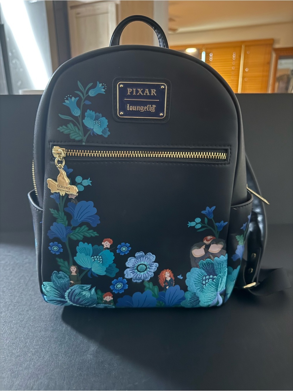 Loungefly Pixar Black Mini Backpack with Blue Floral Print